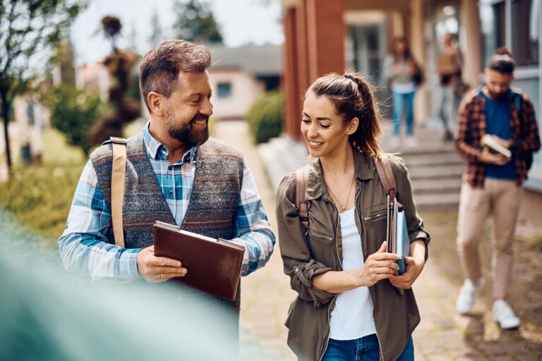 Professor and student walking across campus